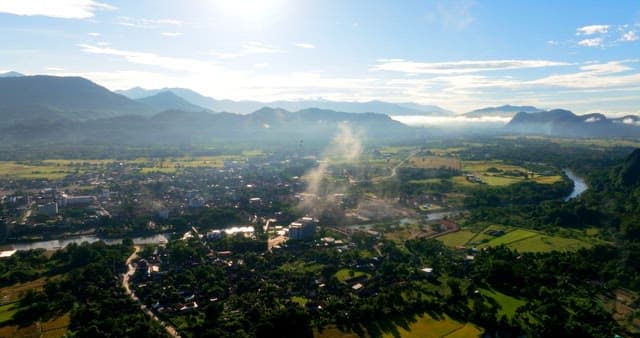 Aerial View of a Village Full of Greenery at Sunrise