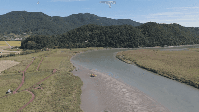 Winding river flowing through green fields