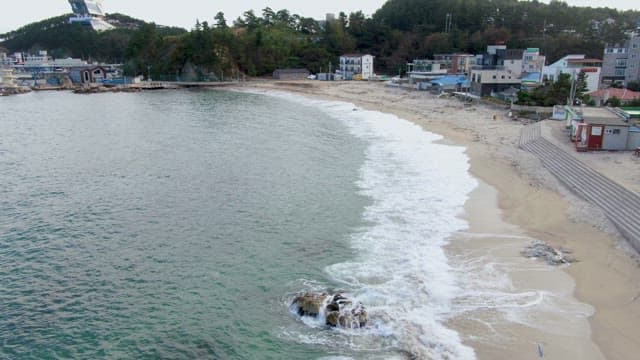 Coastal town with waves hitting the shore