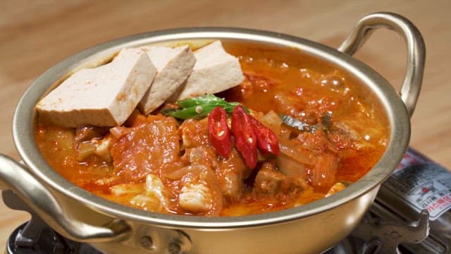 Spicy Kimchi Stew Boiling in Traditional Pot