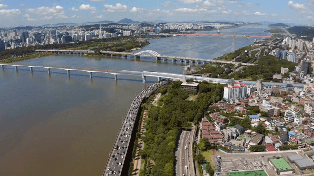 Bustling city with a river and bridge
