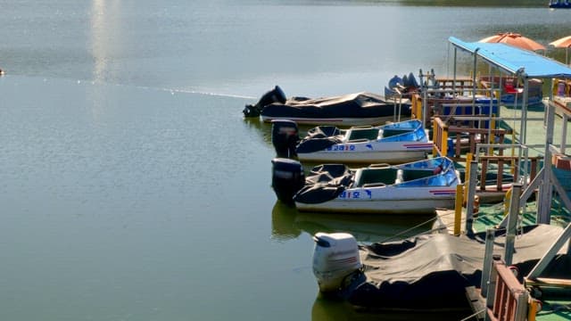 Dcked small boats on a calm lake on a sunny day