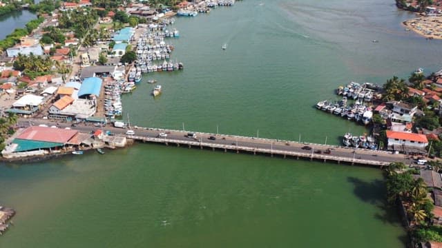 Coastal town with a bridge over a river on a sunny day