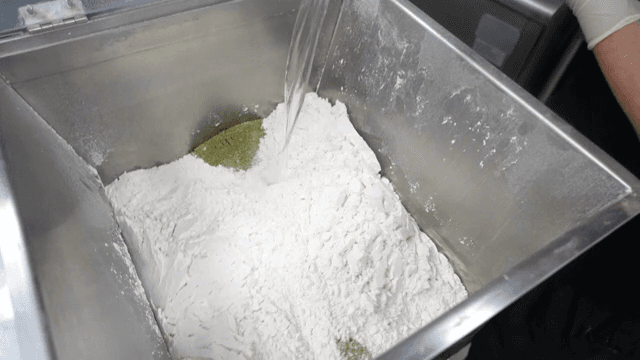 Mixing water with flour in a kitchen
