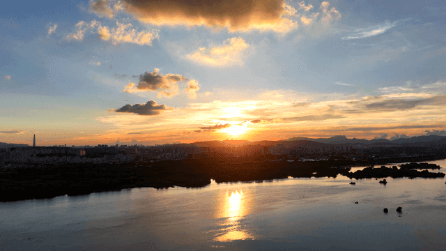 Sunset over a city skyline and river