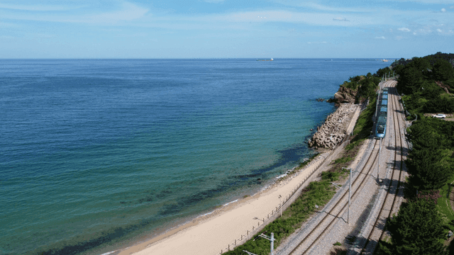 Train running along coastal railway