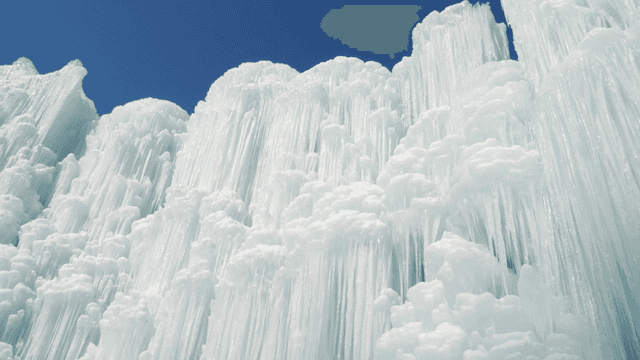 Majestic frozen waterfall under clear sky