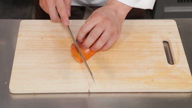 Slicing a piece of liver tingray of on a cutting board