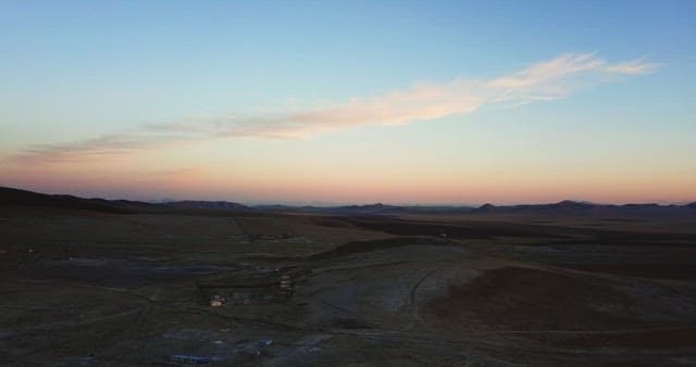 Landscape of barren fields with distant hills