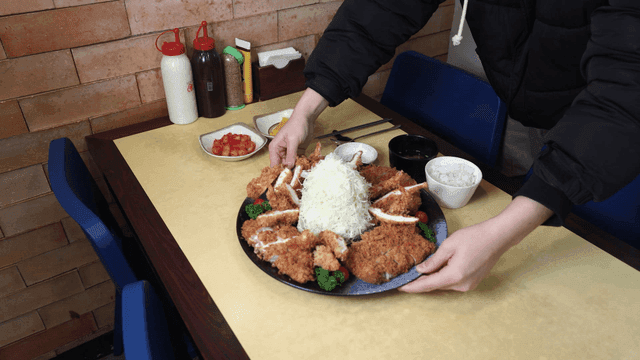 Table with pork cutlet and side dishes