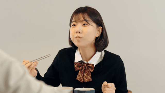 High school daughter eating variety of side dishes