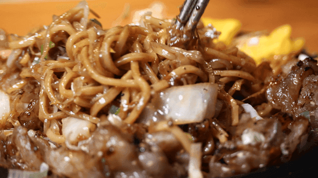 Chopsticks for mixing stir-fried noodles on hot plate