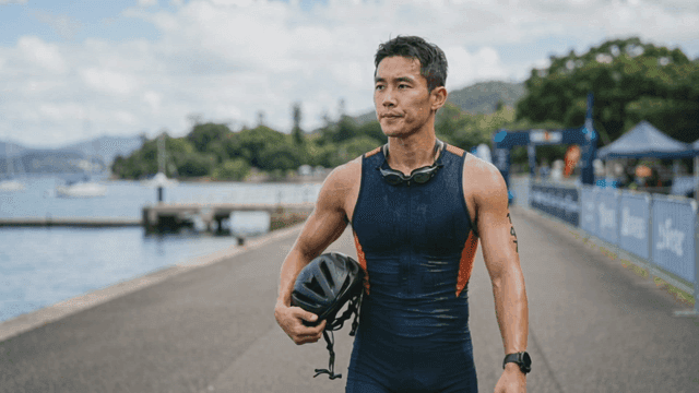 Athlete standing by the waterfront after a race