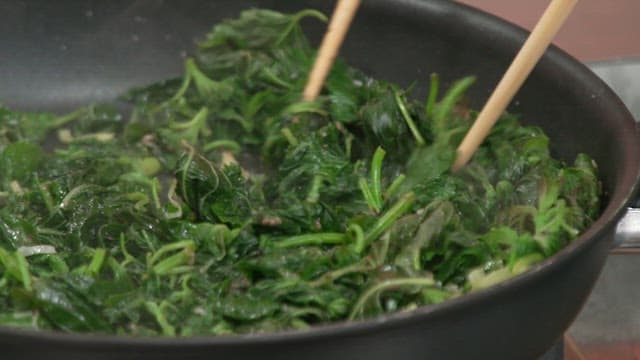 젓가락으로 팬에서 깻잎을 볶는 모습