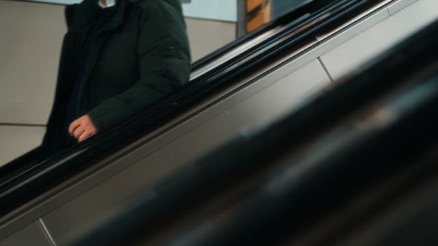 People on an escalator in a busy subway station