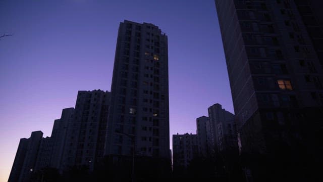 Apartments Lined up Under a Purple Sky at Dusk