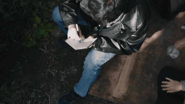 People gathered in a forest discussing