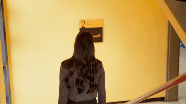 Back view of woman descending stairs