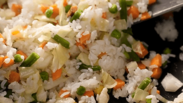 Colorful vegetable fried rice being cooked