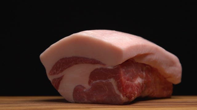 Close-up of raw pork with fat layers