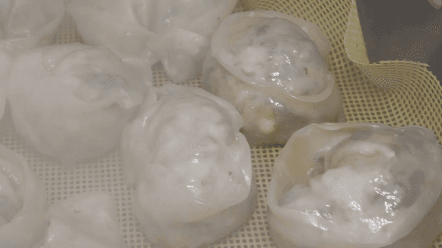 Steaming dumplings on a mesh tray