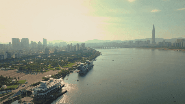 A city skyline with a river and skyscrapers