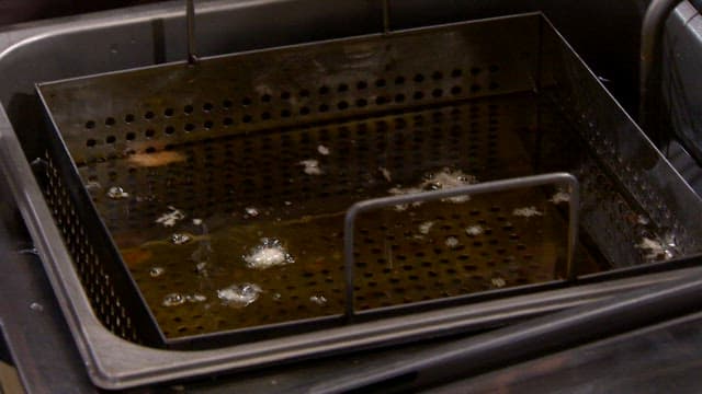 Frying breaded pork cutlet in hot oil