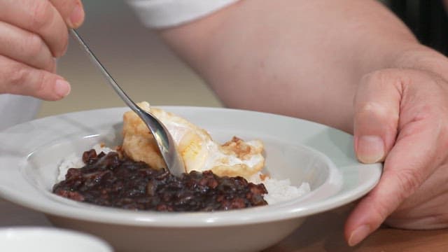 Eating Black Bean Sauce with Rice with a Fried Egg at the Table