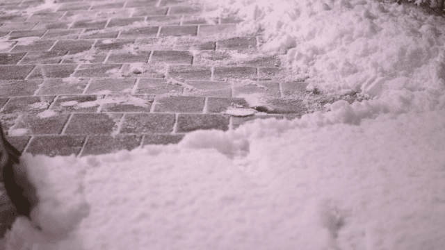 Person clearing snow from road