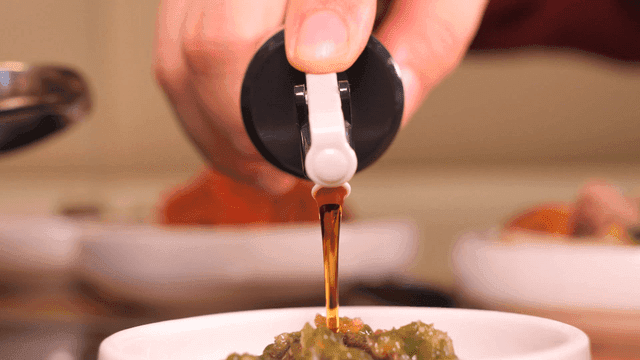 Soy sauce poured over small plate containing minced chili seasoning