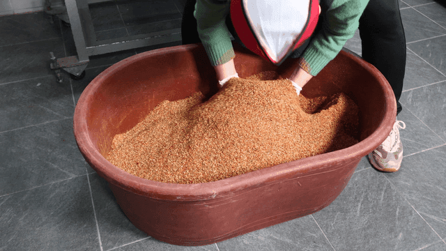 Chef mixing spices in large basin