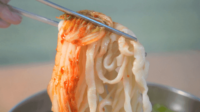 Bowl of kimchi and hand-cut noodles