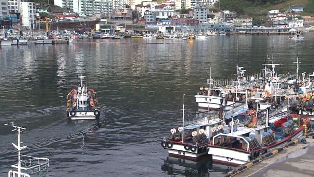 Fishing Boat Leaving a Peaceful Dock