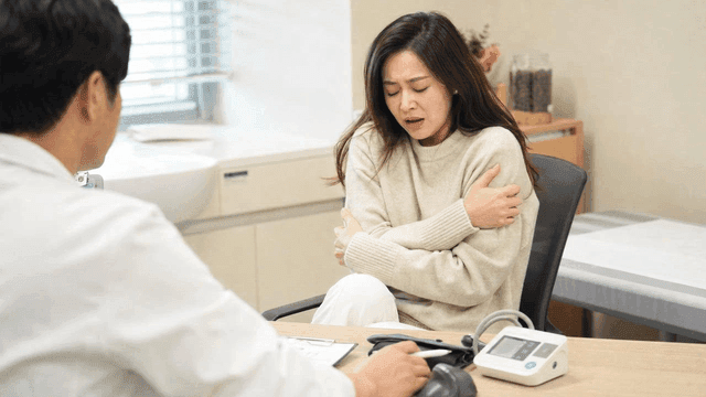 Female patient with chills consulting with doctor at hospital