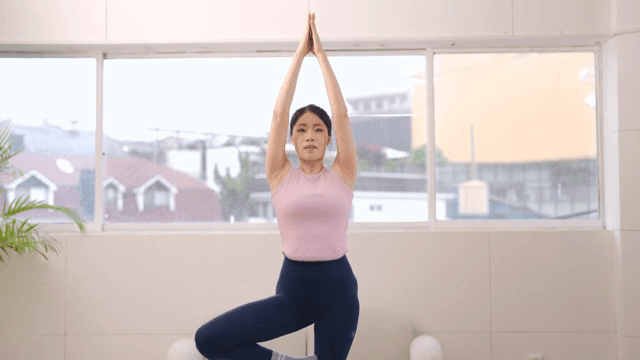 Woman practicing yoga indoors