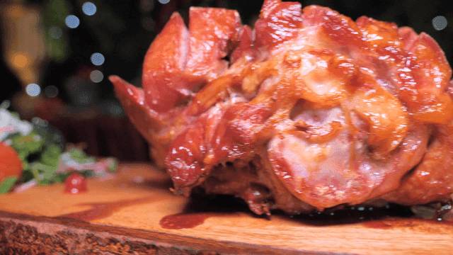 Juicy roast turkey leg on wooden cutting board