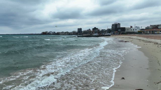 Beach with waves and surfers