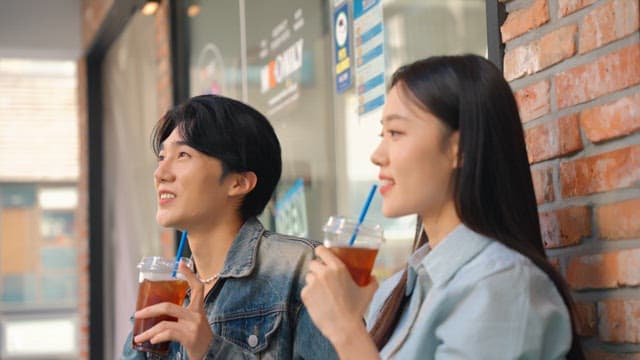 Couple enjoying iced coffee outdoors