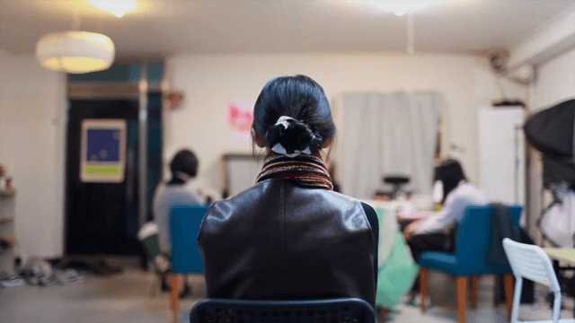 누군가와 대화하고 있는 여성의 뒷모습