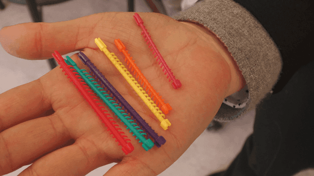 Colorful plastic strips on a person's hand