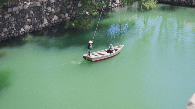 Two people on a boat in a serene river