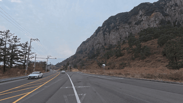 Winding road next to mountain