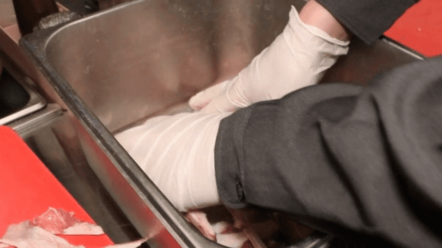 Preparing lamb racks in a kitchen