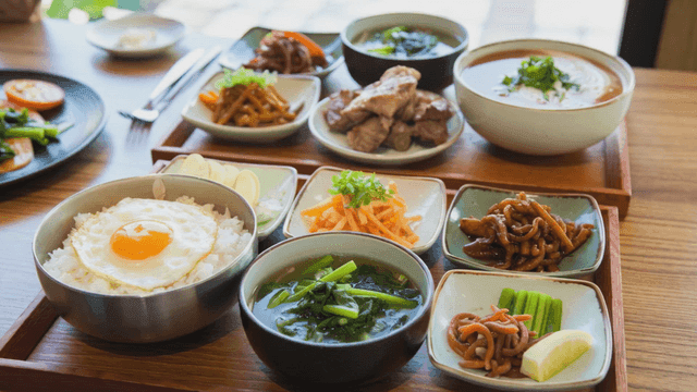 Table full of various Korean dishes on table
