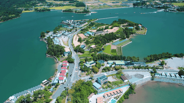 A scenic island with lush greenery and buildings