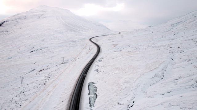 Winding road through snowy mountains