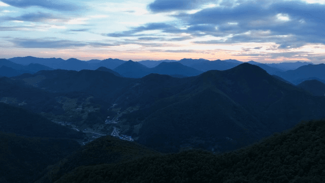 Green mountains under a clear sky