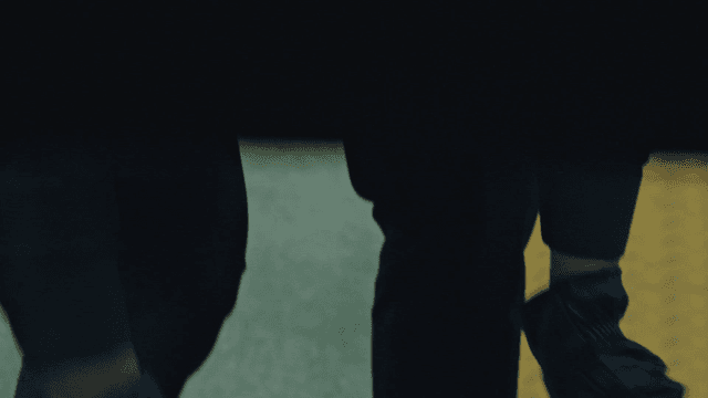 Person in black tying a plastic bag tightly