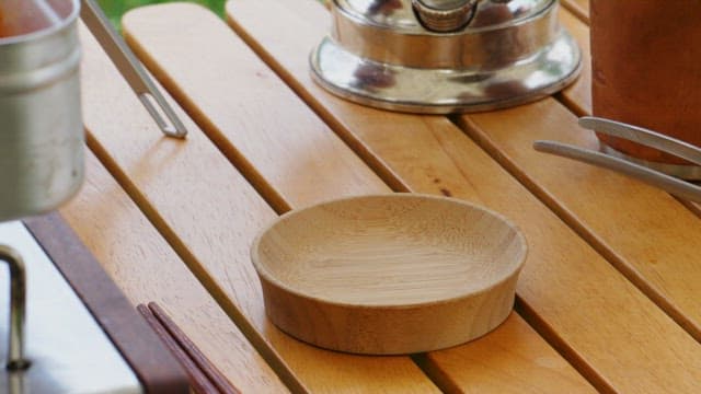 Preparing kimchi on a wooden outdoor table