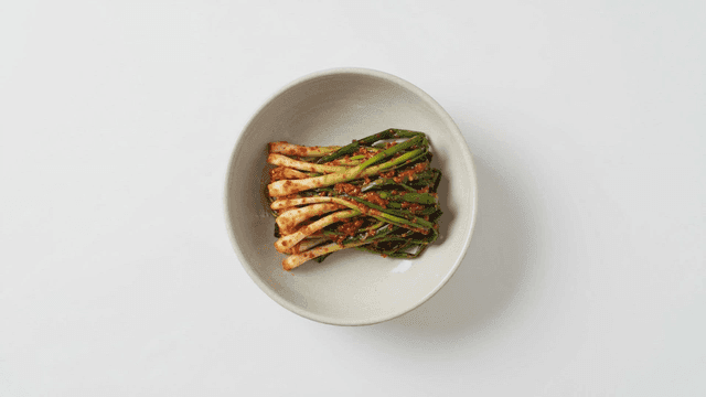 Bowl containing freshly made green onion kimchi